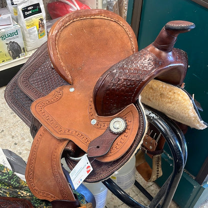 Brown leather saddle with a tag on a store shelf