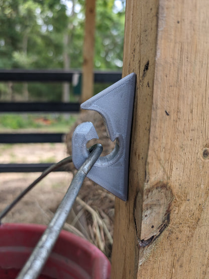 Metal tool being used on a wooden surface with a blurred background